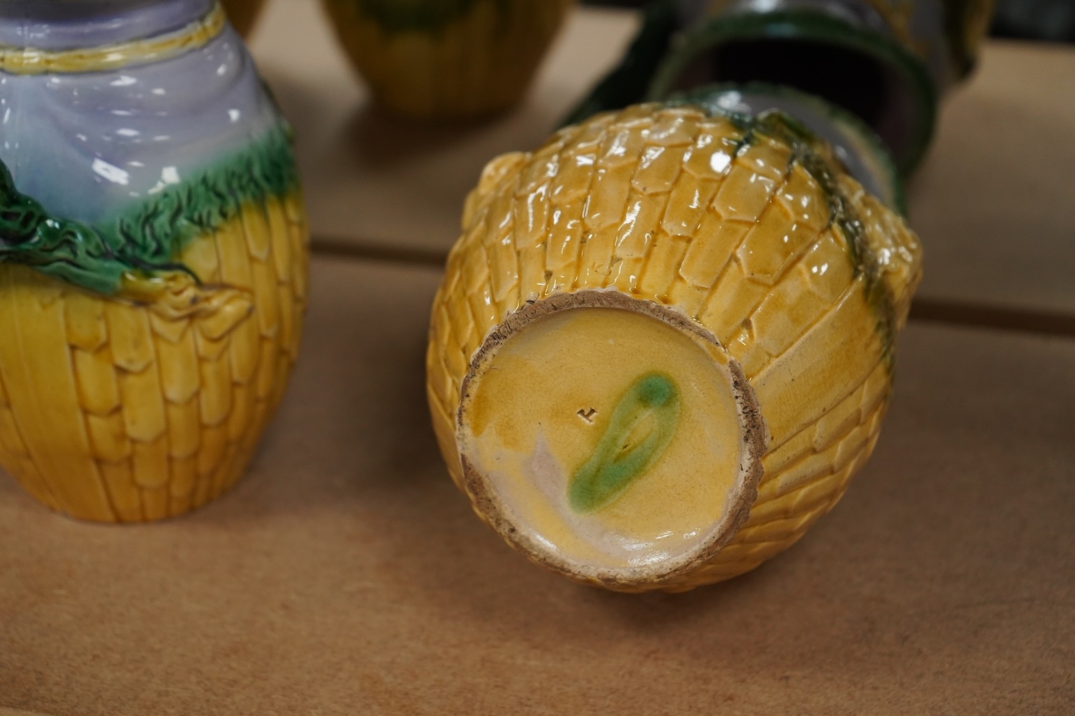 A graduated set of three maiolica ram decorated jugs, tallest 23cm high.